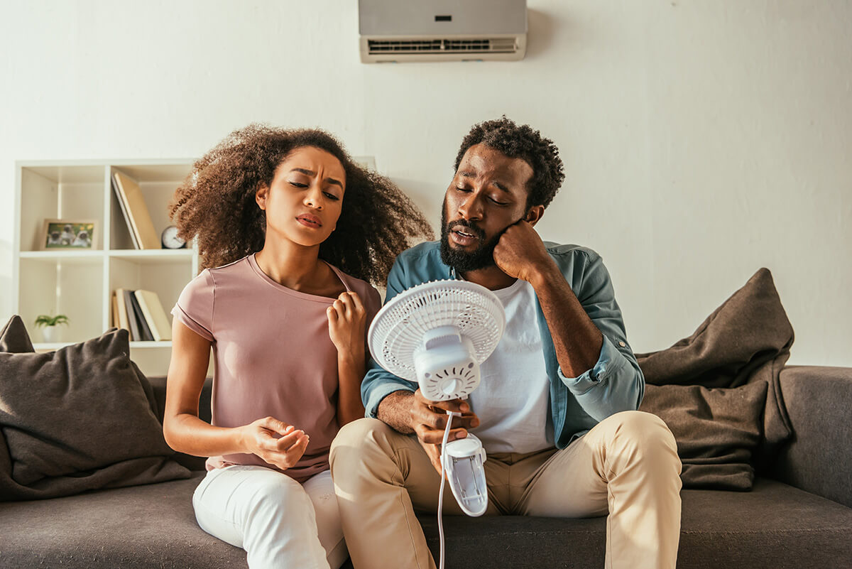 man and woman holding blowing electric conditioner