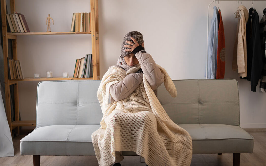 man feeling cold wearing warm winter clothes